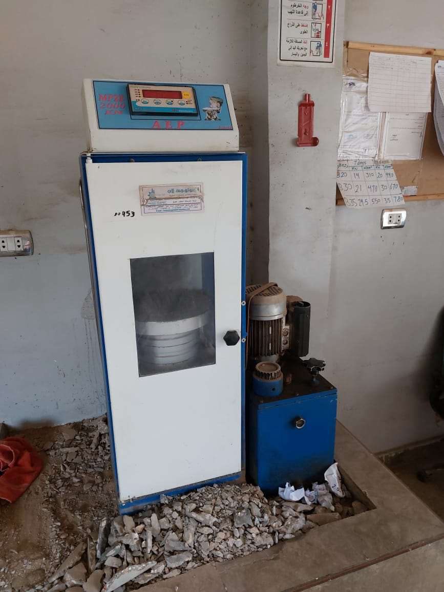 Concrete compression testing machine in a quality control laboratory
